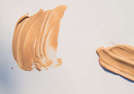 Beige Foundation for make-up, cosmetic touches on white backgroundの写真素材