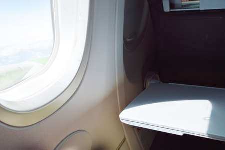 The window on the plane, a table for easy travel. Enjoy your flight