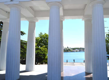 View of the white columns and the sea promenade on a Sunny summer day, resort, tourist attractionの写真素材