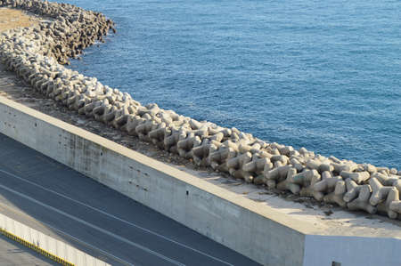 View of the stone and concrete breakwaters along the pier, the port of Civitavecchia, on 7 October 2018の写真素材