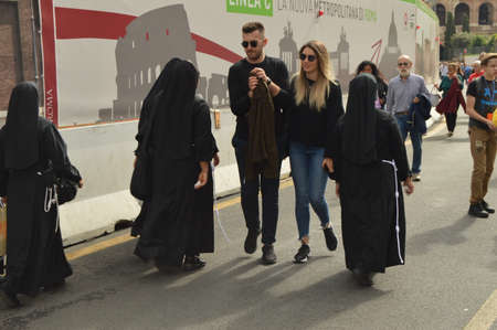 Italy, Rome, October 07, 2018, Nuns in black clothes walking down the street of Rome among tourists.のeditorial素材