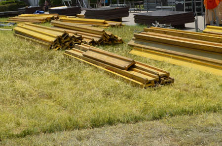 Old boards for the installation of the Foundation of the veranda lie on the grass.