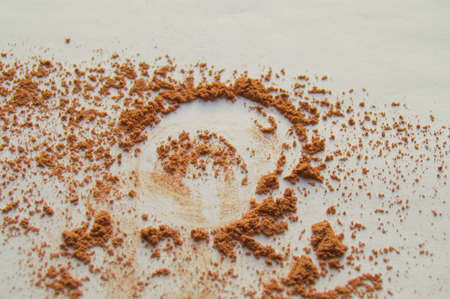Scattered beige powder, Crumbles natural makeup powder on white background.の写真素材