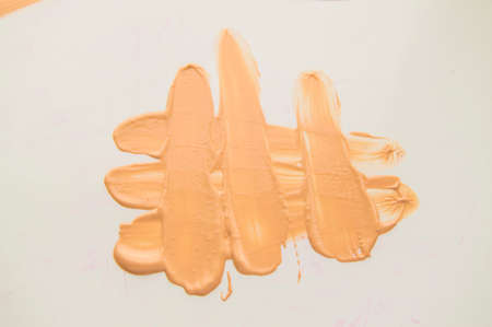 Liquid Foundation stain on white background. Surge of concealer highlighter.