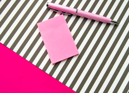 Flat lay, top view office workplace background. Black and white stripes, stickers, fountain pen.