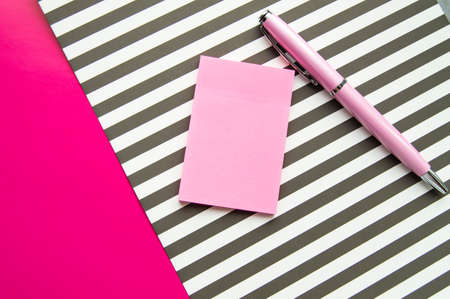 Flat lay, top view office workplace background. Black and white stripes, stickers, fountain pen.の写真素材