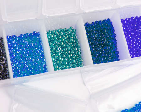 Fletley, plastic box with colorful beads for creativity and hobby, Bright sparkling beads on white backgroundの写真素材