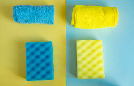 Flat lay, top view. Detergents and cleaners yellow and blue. The concept of cleaning.の写真素材