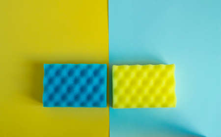 Flat lay, top view. Detergents and cleaners yellow and blue. The concept of cleaning.の写真素材