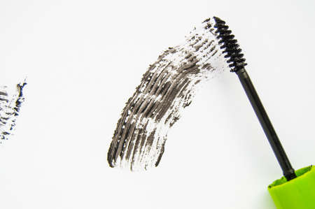 Black ink smear and green brush isolated on white.の写真素材