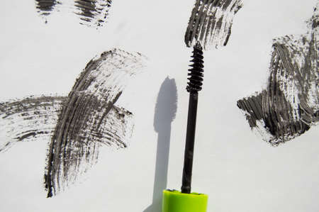 Black ink smear and green brush isolated on white.の写真素材