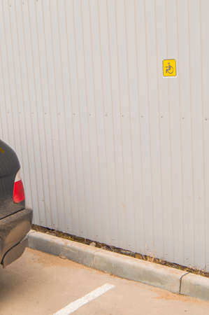 Reserved Parking sign for disabled small size on metal fence, accessible environment for people with...