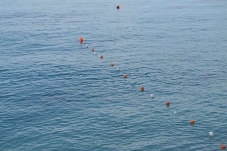 Separation buoys in the sea for safe swimming on the beach.の写真素材