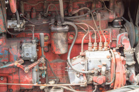Close-up of old dirty tractor diesel engine parts.