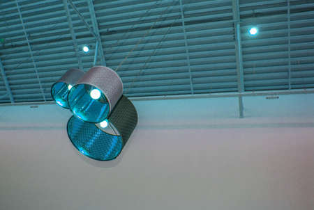 Ultra-modern loft style in blue toned color decorative lamps and lampshades hang on long rope,...