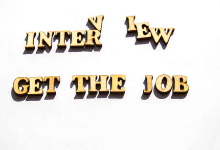 Wooden letters with a sharp shadow on a white background written word interview get the job search, the concept of interview for employment , recruitment.の写真素材