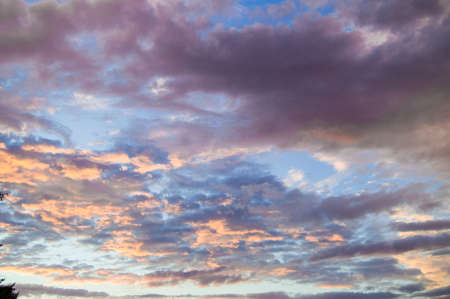 Colorful summer sunset after rain with dramatic blue and pink clouds, weather concept, seasonal...