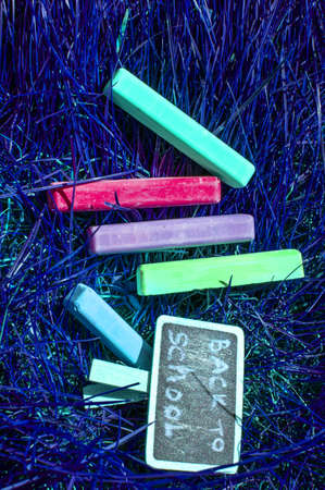 Back to school background with colorful neon colored crayons, on purple glowing background. Flat position, top view, copy space. Dream studentの写真素材