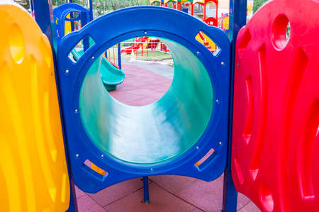 Colorful children's Playground with slides and swings outdoors in the Park in summer.の写真素材