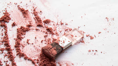 Diffuse blush or beige brown colored loose face powder and makeup brush isolated on white background. Top view.の写真素材