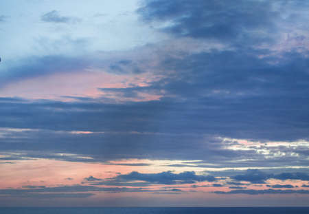 Calm sunset or sunrise over the Mediterranean sea, the sun shining through soft blue and pink...