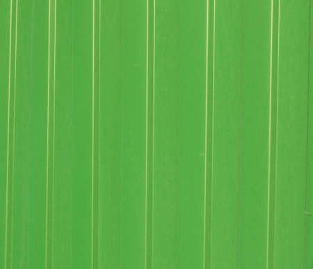 Green metal corrugated siding, modern finishing material for construction, background texture.の写真素材