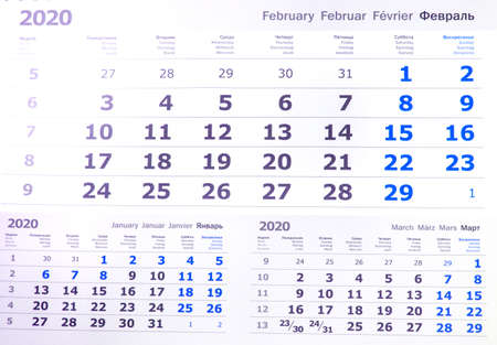 February 2020 calendar or desktop planner, top view, text in 4 languages English, German, French,...