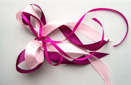 Pink and purple ribbon isolated on a white background, the concept of decorating gifts and postcards.の写真素材