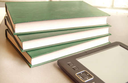 Modern educational technologies, e-book next to a stack of books, the concept of digital learning...