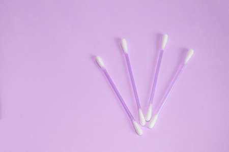 Top view, flat lay, pink plastic cotton buds neatly laid out on a pink background, the concept of cleanliness and hygiene.の写真素材