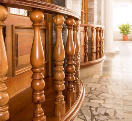 Luxury interior of the empty hotel with elegant oak balusters and sunlight.の写真素材