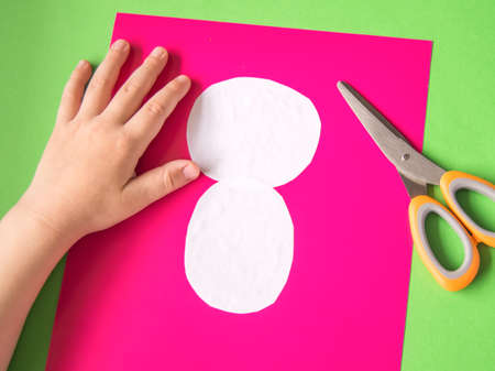 Step 4. Child glued Panda's head and torso. The concept of DIY and children's creativity. Step-by-step instructions: paper Panda application. Creative activities with a child during quarantine.の写真素材