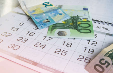Euro and us dollar banknotes on the calendar. Tax report, crisis, Finance, business and planning.の写真素材