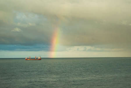 Rainbow in the sea after rain and thunderstorms. Colorful views of the rainbow on the background of...