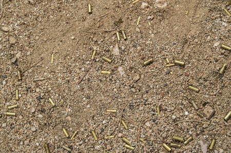 The background of the spent cartridge case on the ground, a place for the text, a copy of the space,...