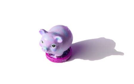 A piggy bank in a shopping basket on a white background and a paper template with the inscription sale.の写真素材