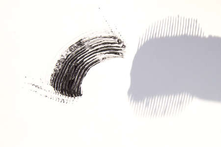 A smear of lipstick in bright pink on a white background.