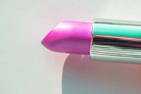 Close-up of a part of a golden tube of lipstick on a white background with a copy of the space on the right.の写真素材