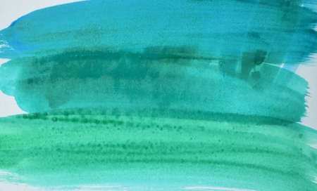 There are many colorful watercolor spots of green and olive color on a white background. Abstract watercolor background.の写真素材