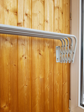 clothes dryer folded, attached to a wooden wall, vertical.