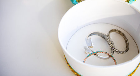 A set of womens metal bracelets in a jewelry box, top view