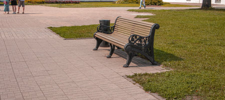 One wooden bench in RETRO style in the recreation area of the city park, summer dayの写真素材