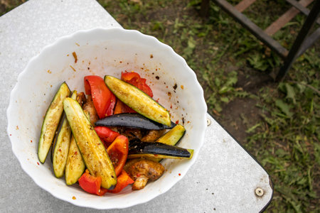 Delicious sliced grilled vegetables. Rustic background lawn and barbecue.の写真素材