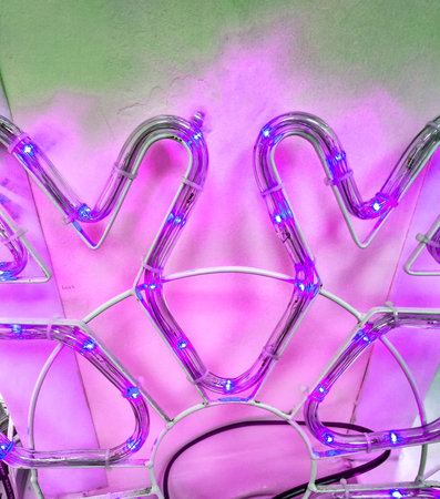 Christmas snowflake made of LED strip, pink tinted, close-up, part.の写真素材