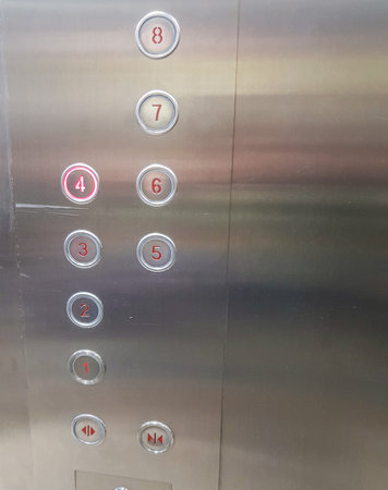 Close-up of the numbers on the buttons in a modern metal elevator, vertical.の写真素材
