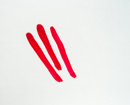 Smears of red nail polish on a white background, beauty concept.の写真素材