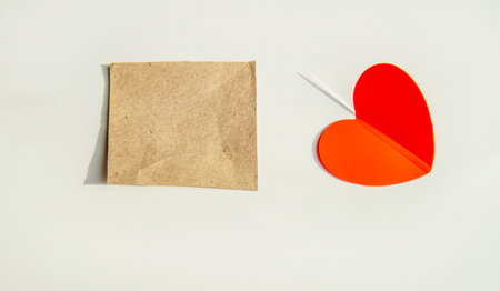 Red heart and square kraft sticker isolated on white background.の写真素材