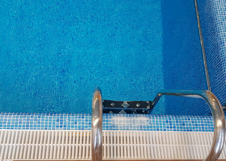 Top view of the metal stairs going down to the pool.の写真素材