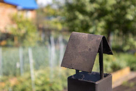 Vintage iron pipe chimney with corner umbrella. Close-up of a pipe from a camp stove.の写真素材