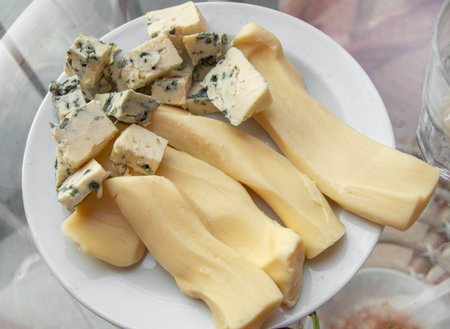 Blue cheese with noble mold, diced, on a plate, top view.の写真素材
